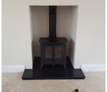 Charnwood Island 1 Stove -  with low legs in black with black slate hearths installed in Ripley, near Woking, Surrey.
